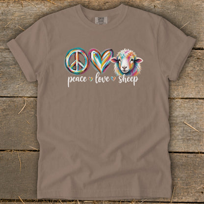 Brown t-shirt with peace sign, heart, and colorful sheep graphic and text.
