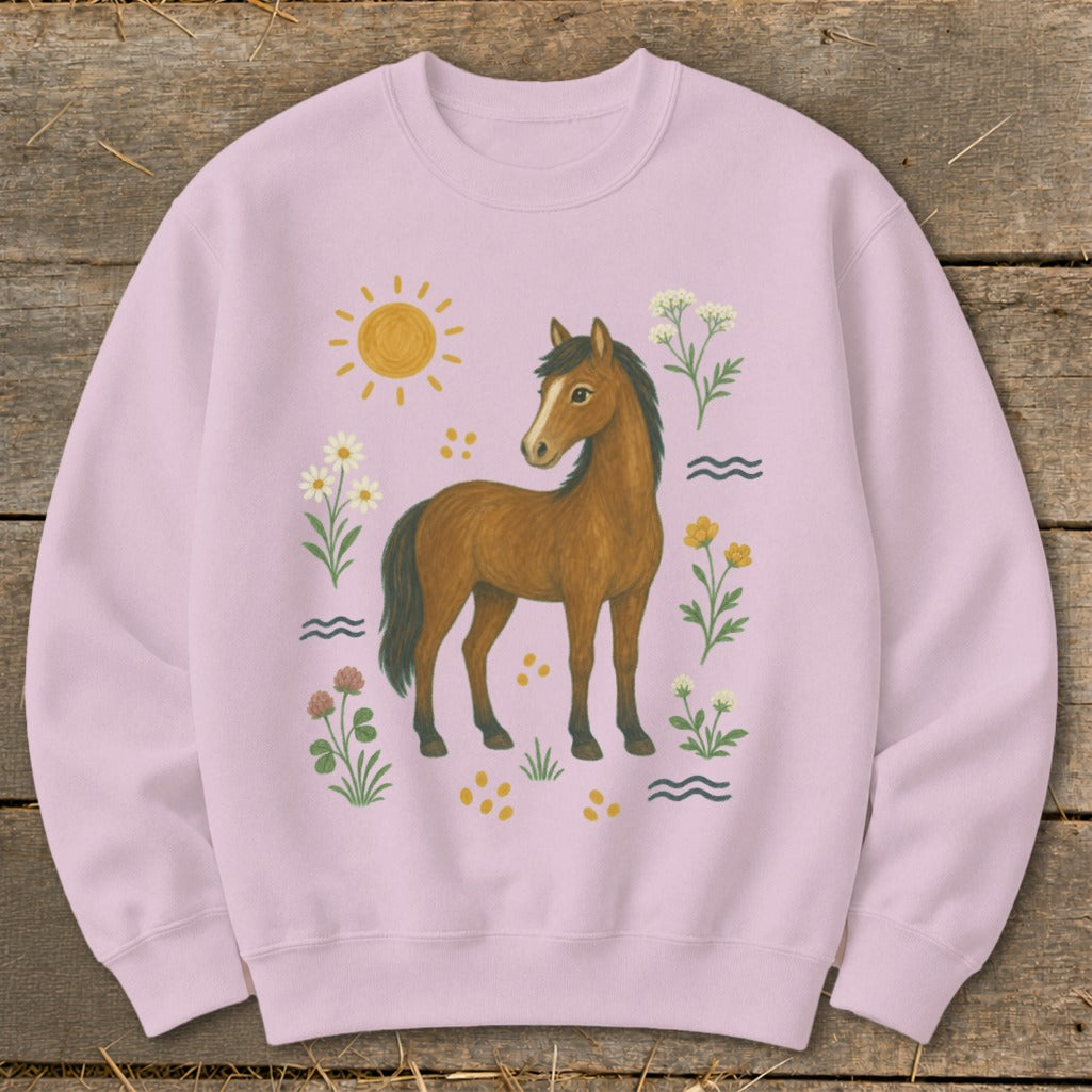Pink sweatshirt with a brown horse surrounded by flowers, sun, and waves.