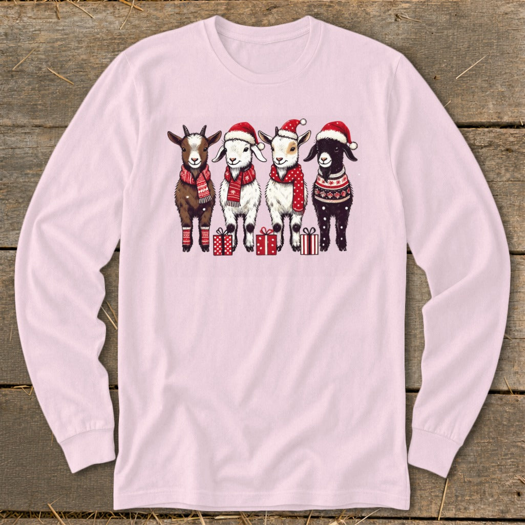 Four cartoon goats wear Santa hats, scarves, and festive sweaters, standing near gifts.