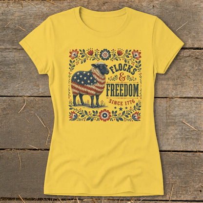 Yellow t-shirt with a sheep patterned with the American flag and text "Flocks & Freedom Since 1776."