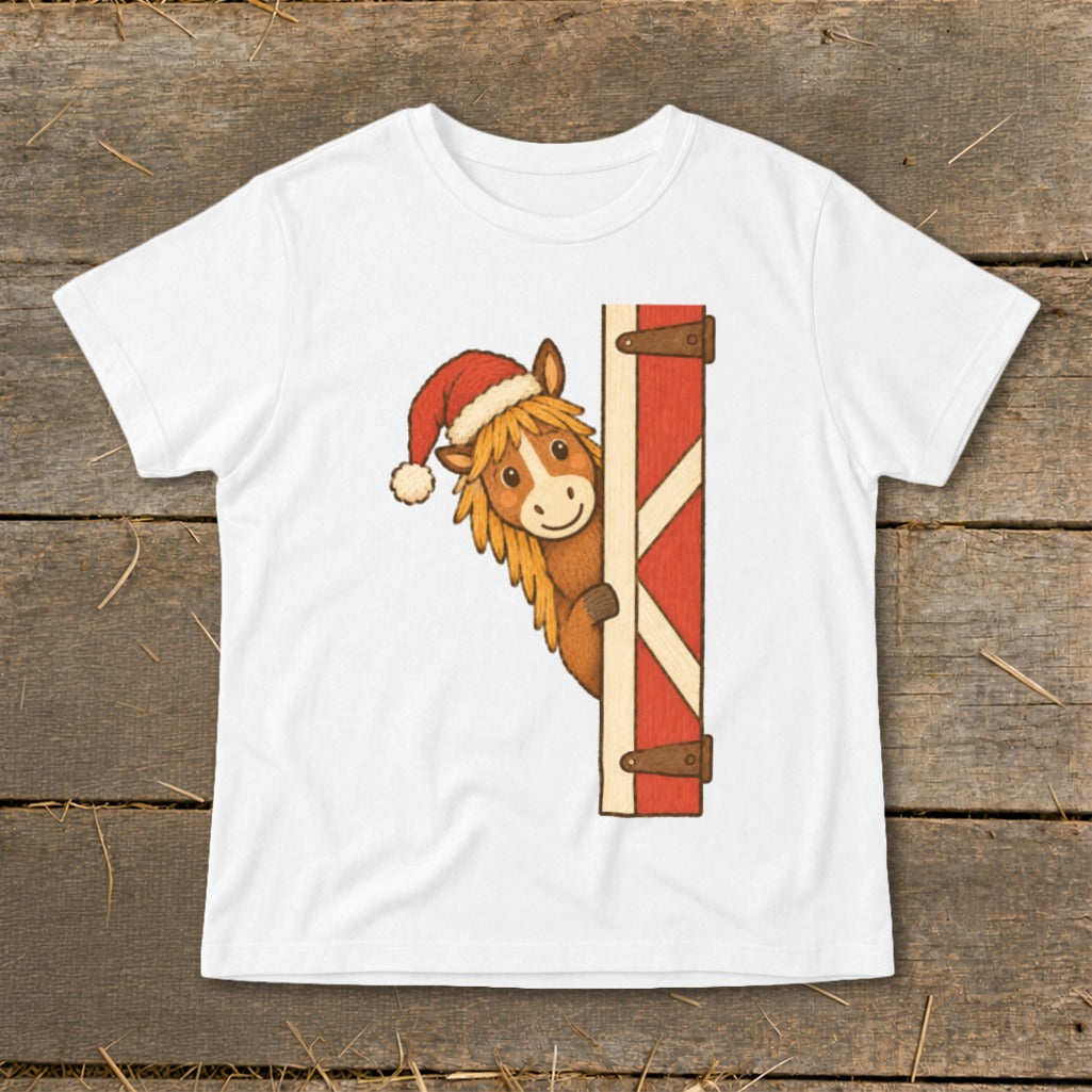 White t-shirt with cartoon horse wearing Santa hat peeking around barn door.