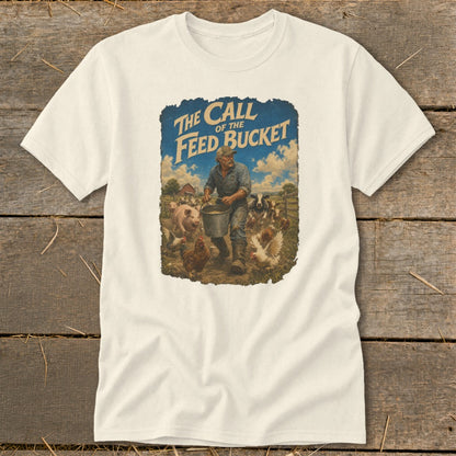 Cream t-shirt with graphic of a farmer feeding farm animals and text "The Call of the Feed Bucket".