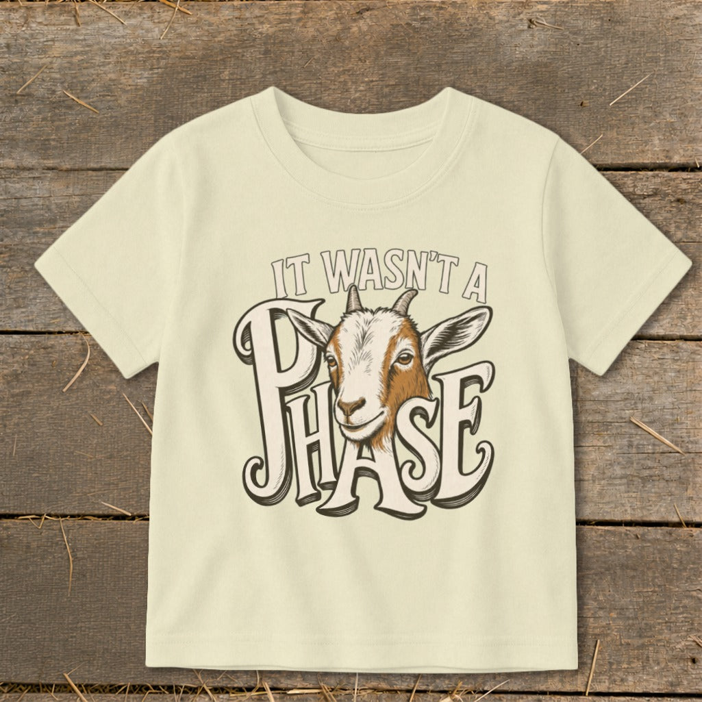 Cream t-shirt with a goat and text "IT WASN'T A PHASE".