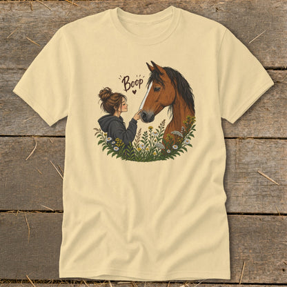 Girl booping a horse's nose with flowers and the word "Boop".
