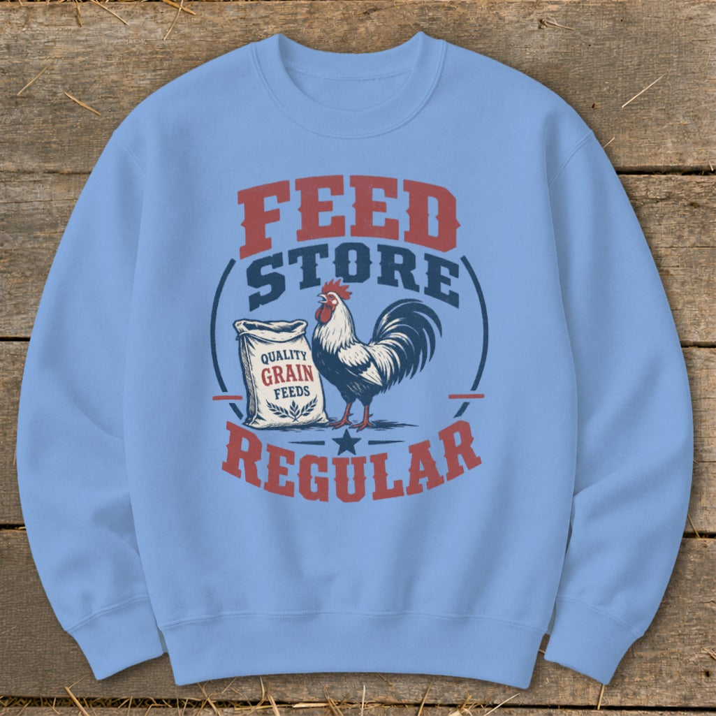 Light blue sweatshirt with "Feed Store Regular" graphic, rooster, and bag of grain.