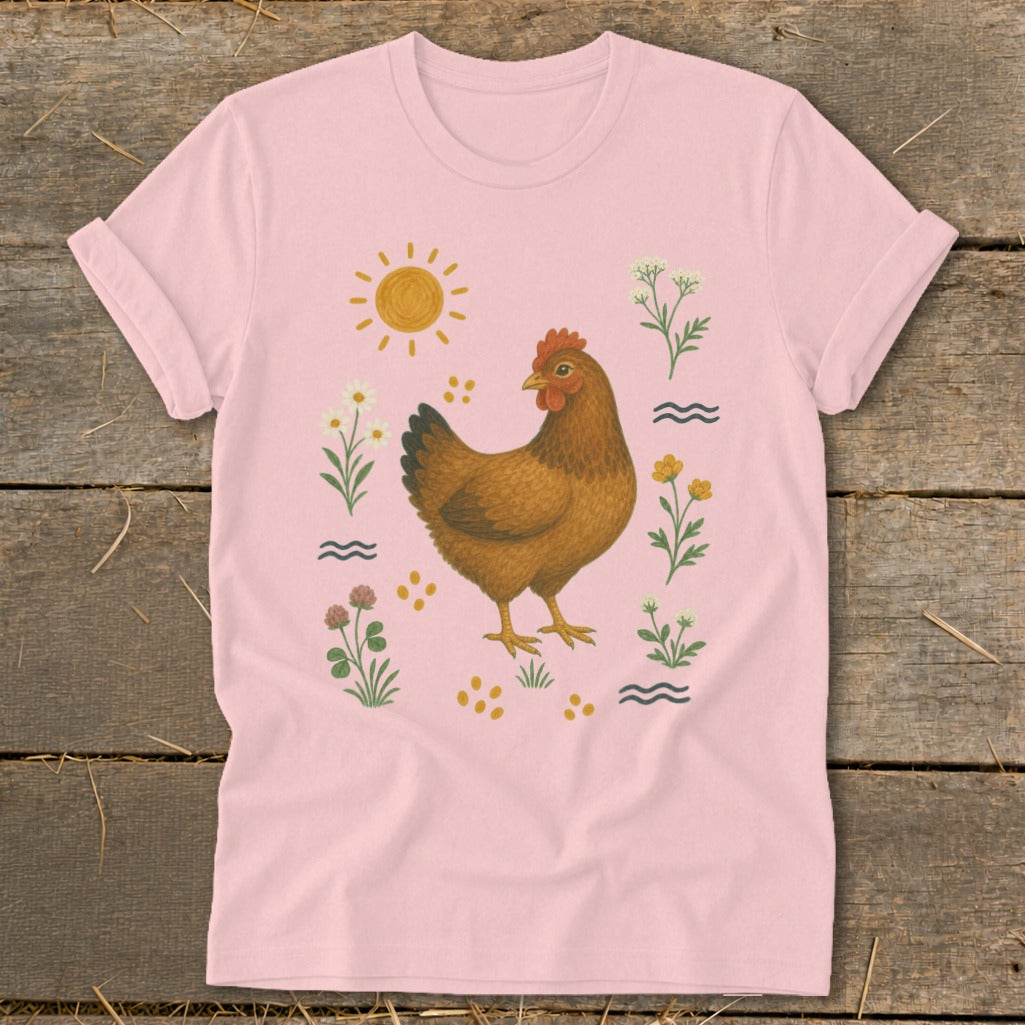 Pink t-shirt with a brown hen surrounded by flowers, the sun, and waves.