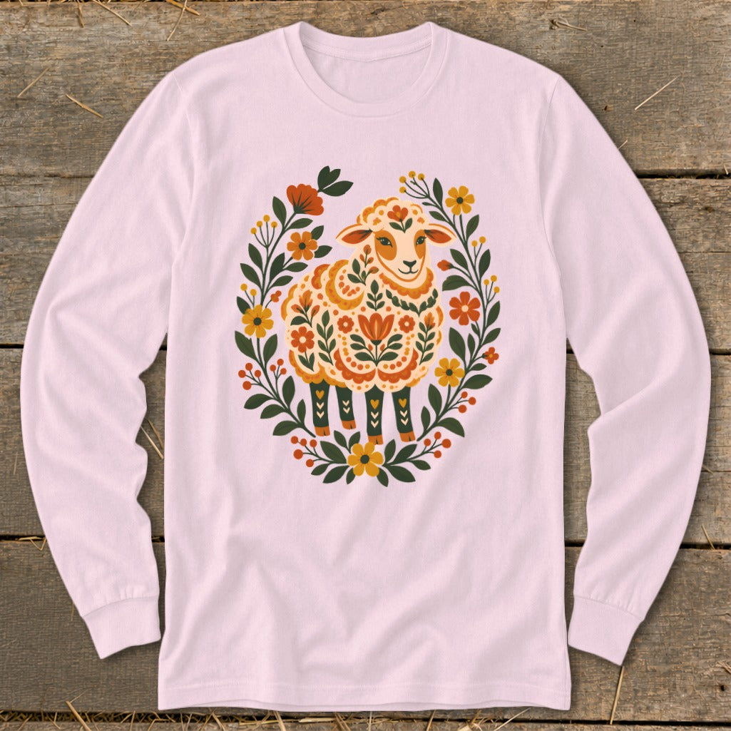 Pink long-sleeve shirt with a folk-art style sheep surrounded by flowers.