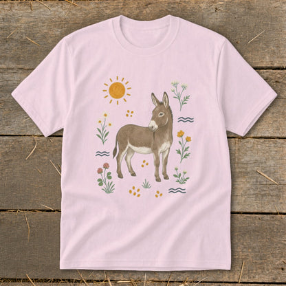 Light pink t-shirt with a watercolor donkey, sun, and wildflowers design.