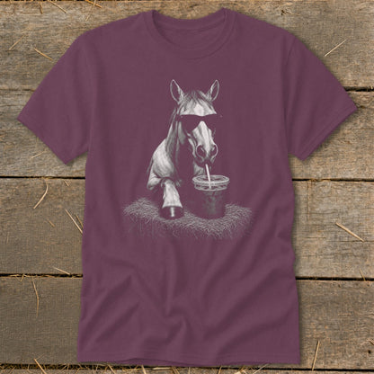 Horse wearing sunglasses drinking from a cup on a maroon t-shirt.
