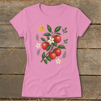 Pink t-shirt with an apple branch design, white flowers, and a sun.