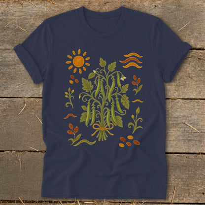 Navy t-shirt with a central bouquet of pea pods and surrounding sun, waves, and scattered seeds.