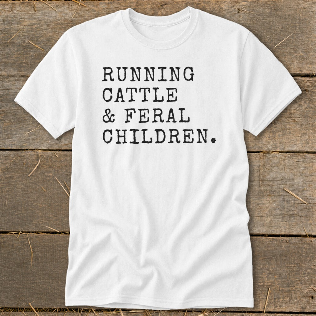 White t-shirt with black text reading "RUNNING CATTLE & FERAL CHILDREN."