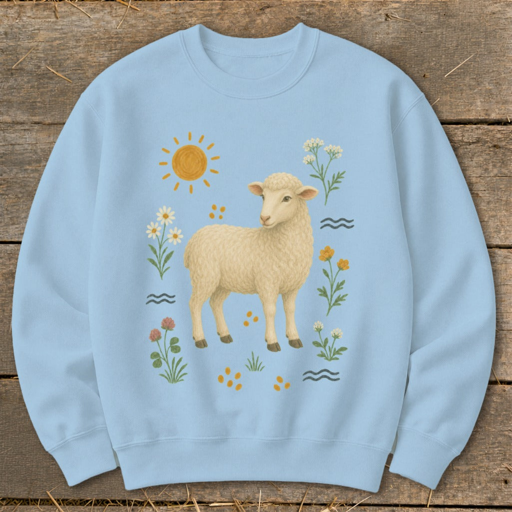 Light blue sweatshirt with a cream sheep illustration and surrounding wildflowers.