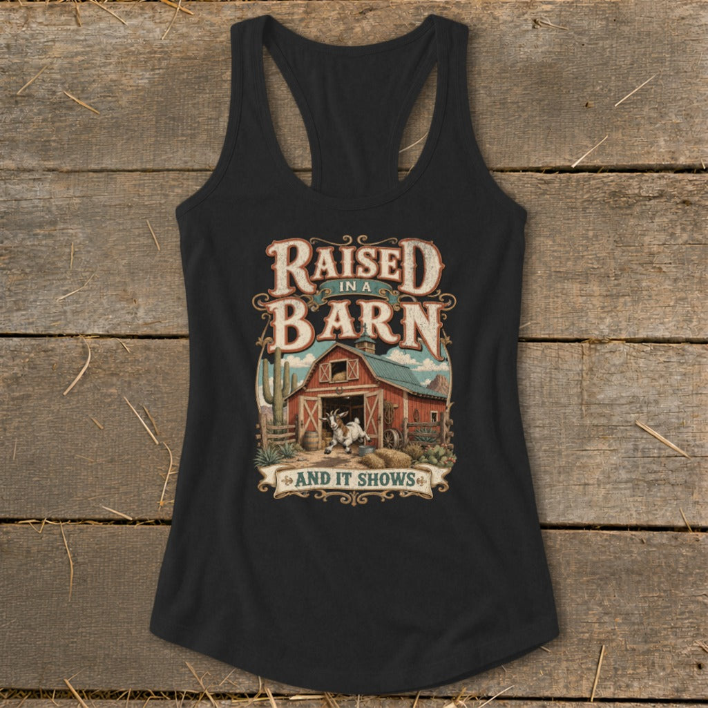 Black tank top with "Raised in a Barn and It Shows" graphic and a goat by a barn.