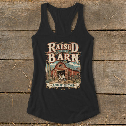 Black tank top with "Raised in a Barn and It Shows" graphic and a goat by a barn.