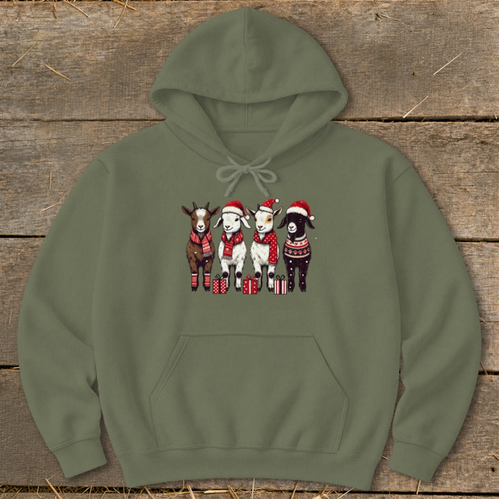 Four goats in Santa hats and scarves stand with presents.
