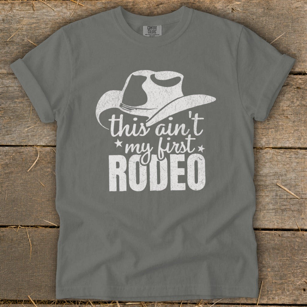 Gray t-shirt with distressed white cowboy hat and text "this ain't my first RODEO".
