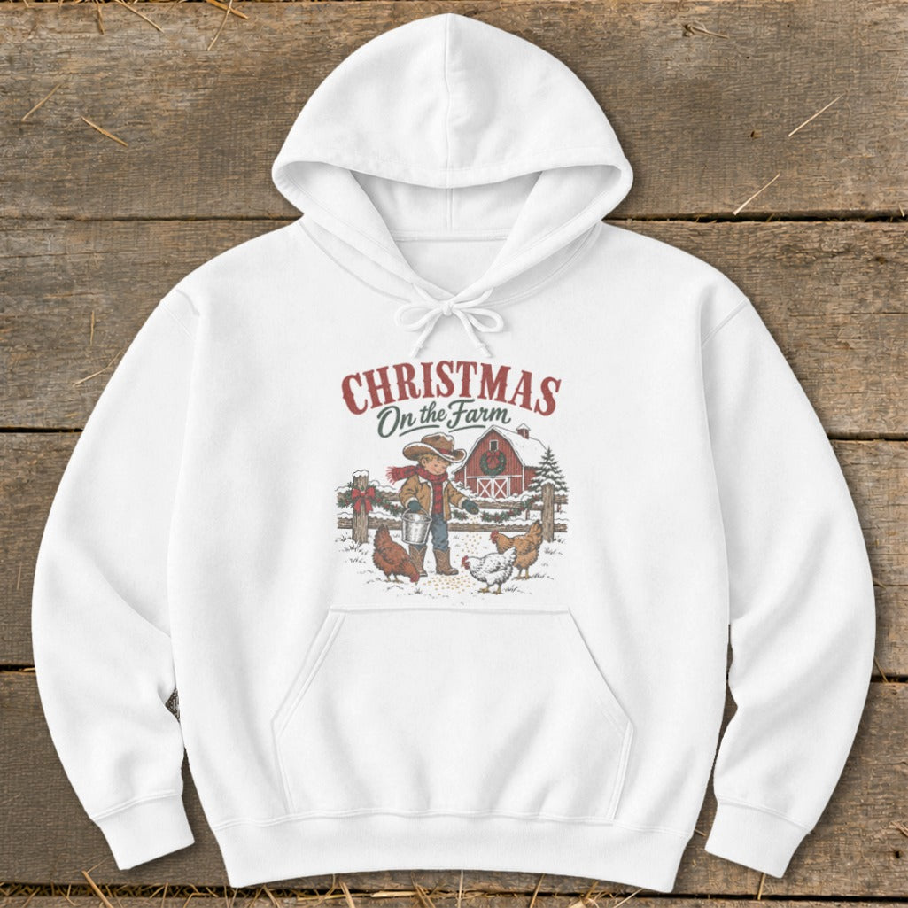 White hoodie with "Christmas On the Farm" graphic of a child feeding chickens.