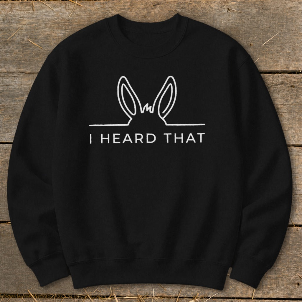 Black sweatshirt with white line drawing of donkey ears and text "I HEARD THAT".