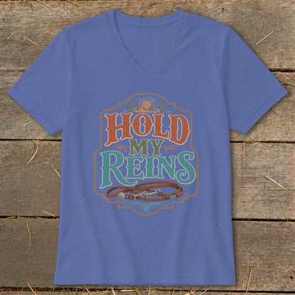Blue v-neck t-shirt with "Hold My Reins" text and horse bridle graphic.
