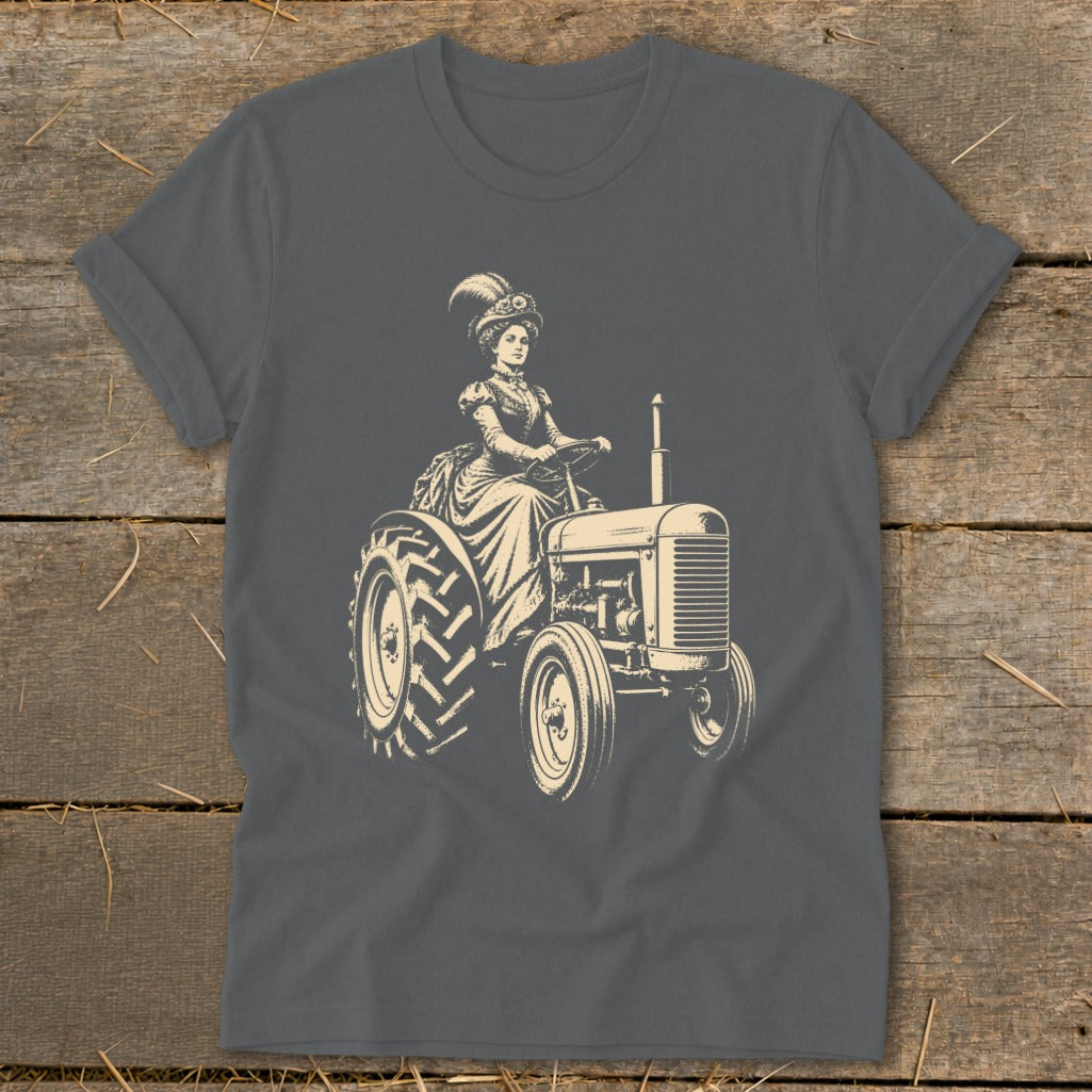Woman in vintage attire driving a tractor with detailed front grille and tires.