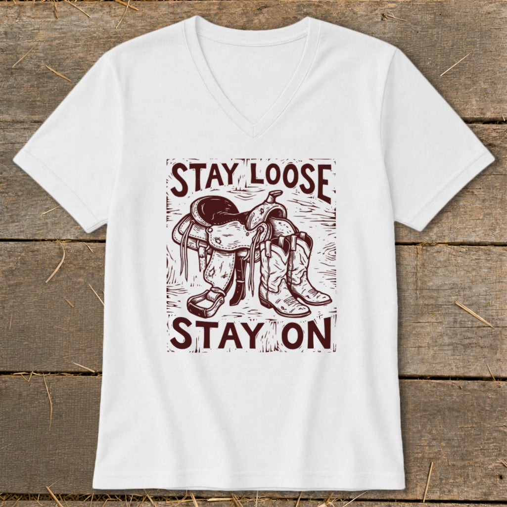White t-shirt with western saddle and boots graphic, text reads "STAY LOOSE STAY ON".