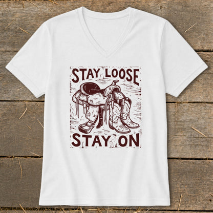 White t-shirt with western saddle and boots graphic, text reads "STAY LOOSE STAY ON".