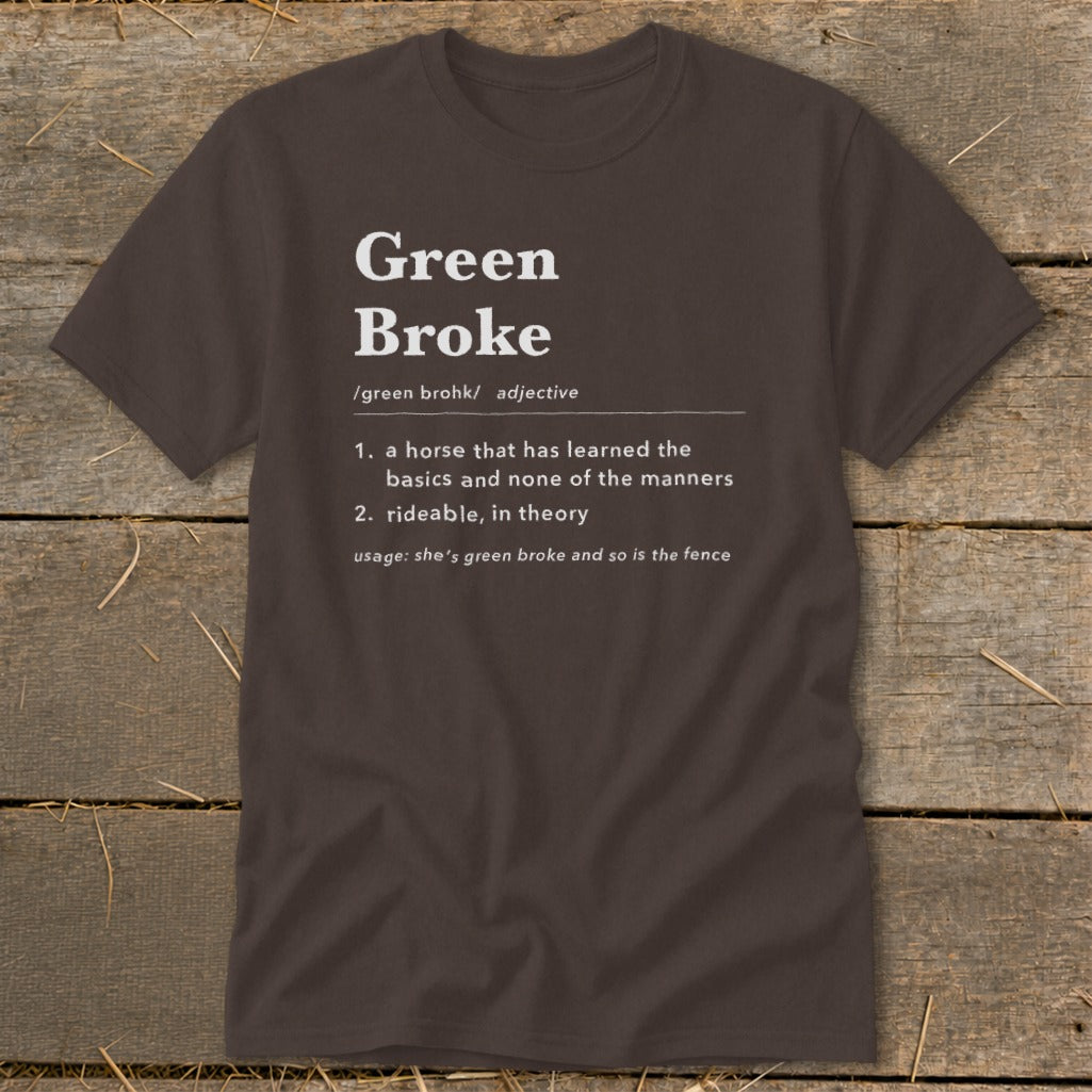 A dark brown t-shirt featuring white text that humorously defines the term green broke.