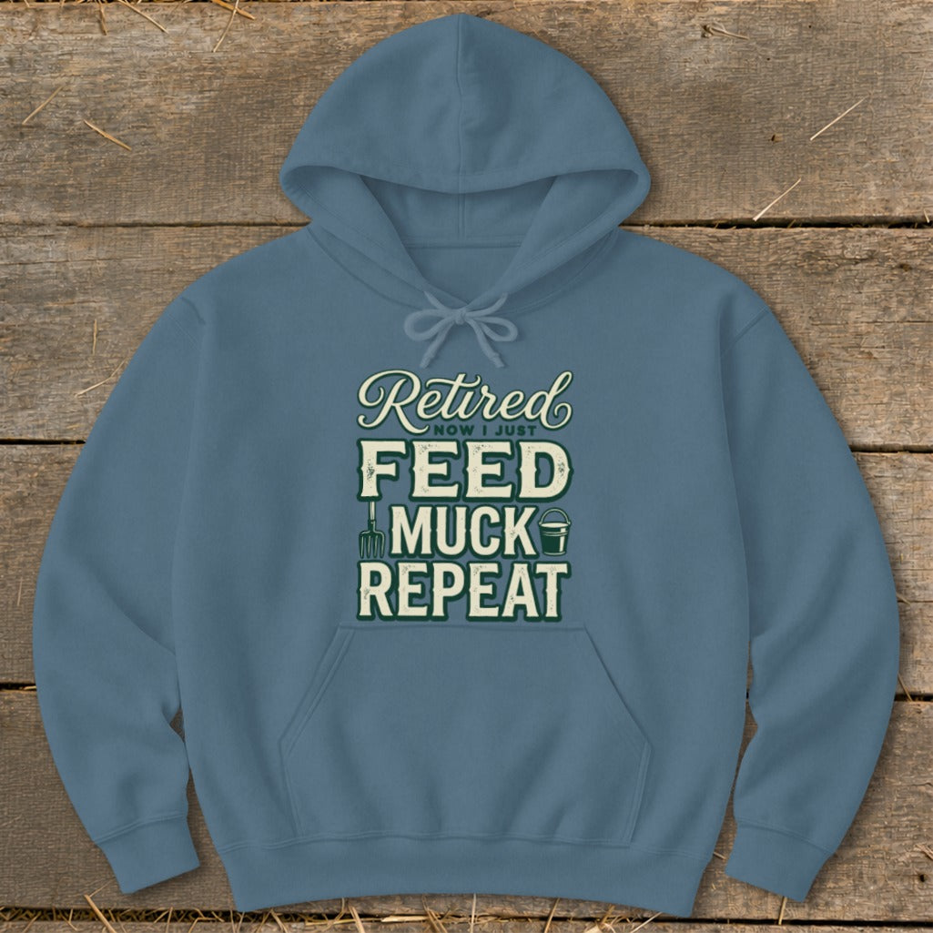 Blue hoodie with text "Retired Now I Just Feed Muck Repeat" and farm icons.