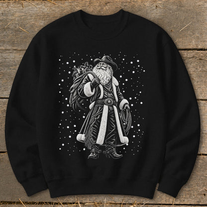 Black sweatshirt with black and white illustration of a cowboy Santa Claus and falling snow.