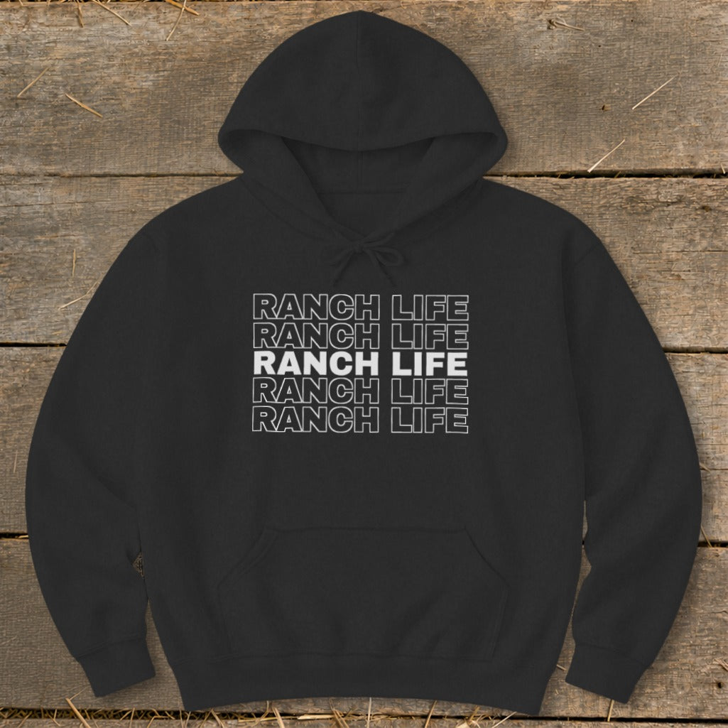 Black hooded sweatshirt featuring repeated white outline text reading Ranch Life on a wooden background.