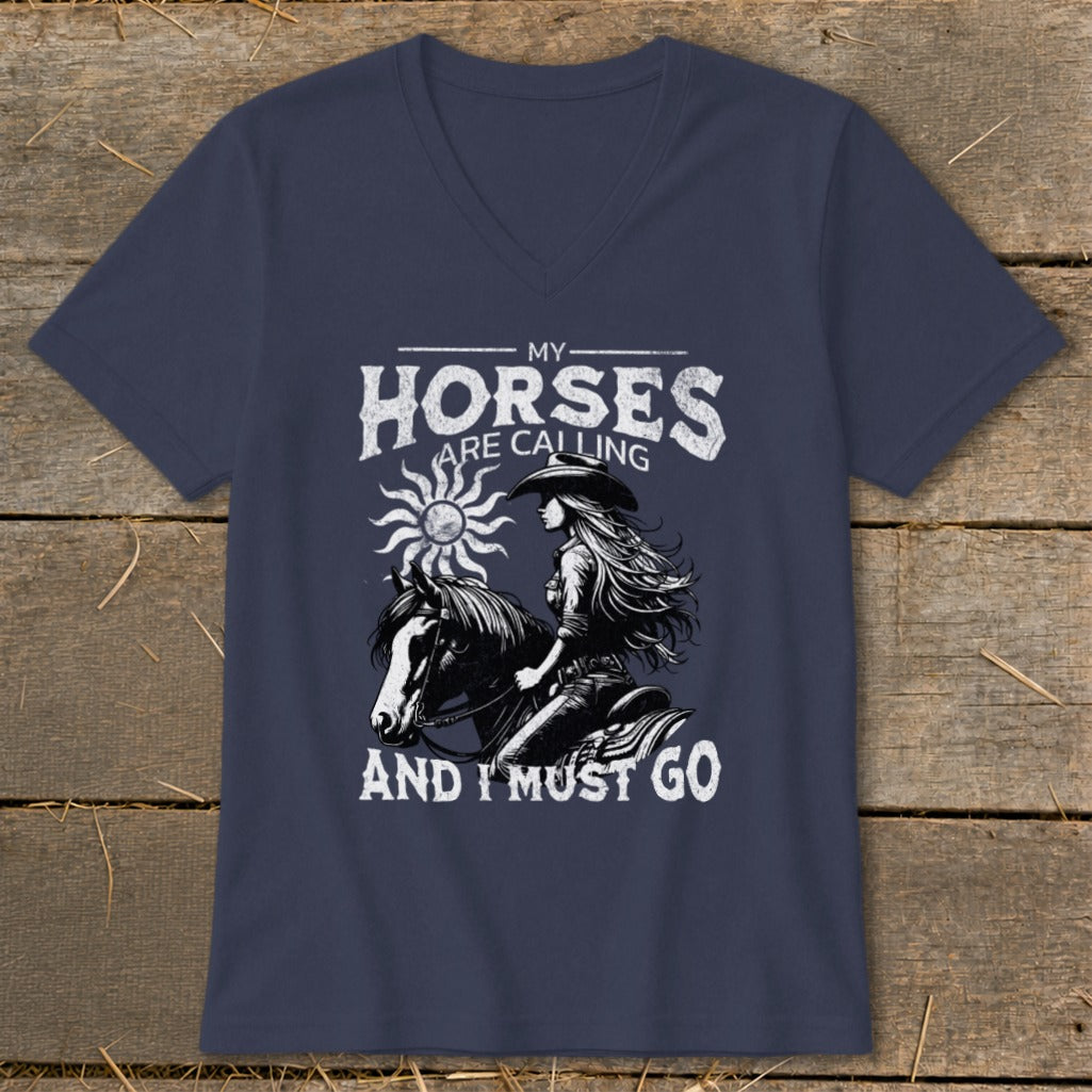 Dark t-shirt with graphic of woman riding horse and text "My Horses Are Calling And I Must Go".