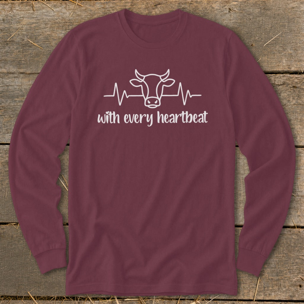 Maroon long sleeve shirt with a white cow heartbeat graphic and text "with every heartbeat".