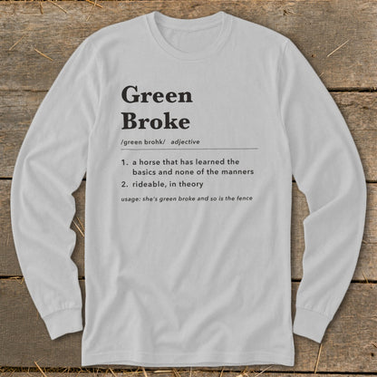 Light gray long-sleeve t-shirt with black dictionary definition text reading Green Broke on a rustic wooden background.