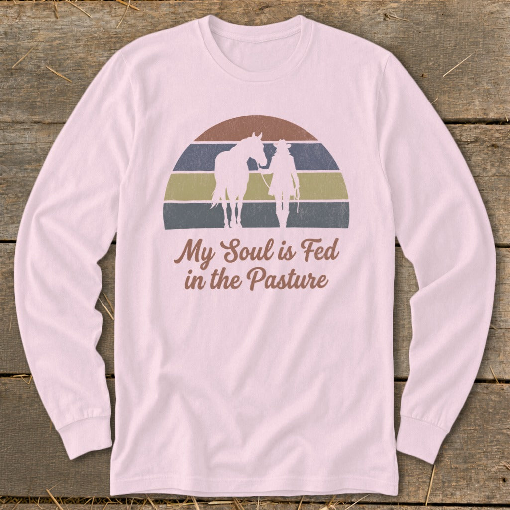 Pink long-sleeved shirt with horse and rider silhouette and text "My Soul is Fed in the Pasture".