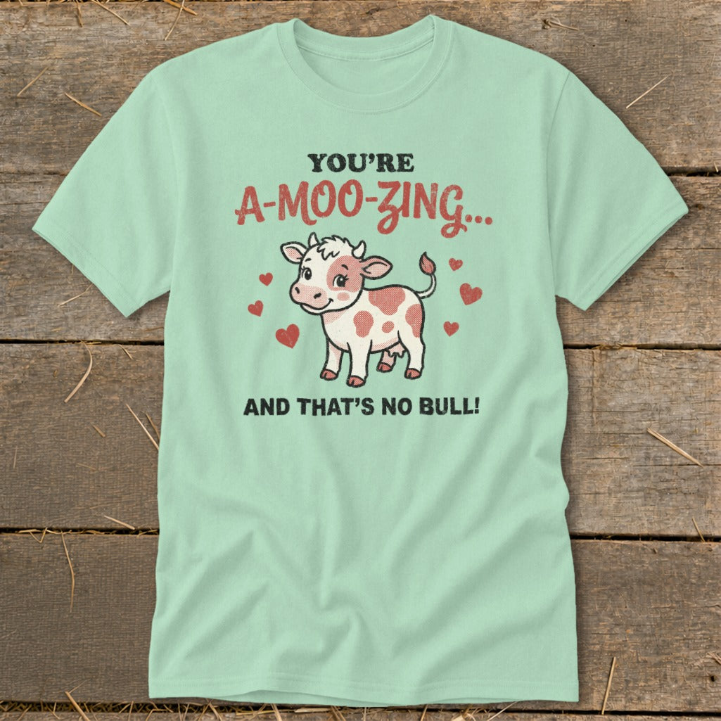 Light blue t-shirt with cow graphic and text "You're A-Moo-zing... And That's No Bull!"