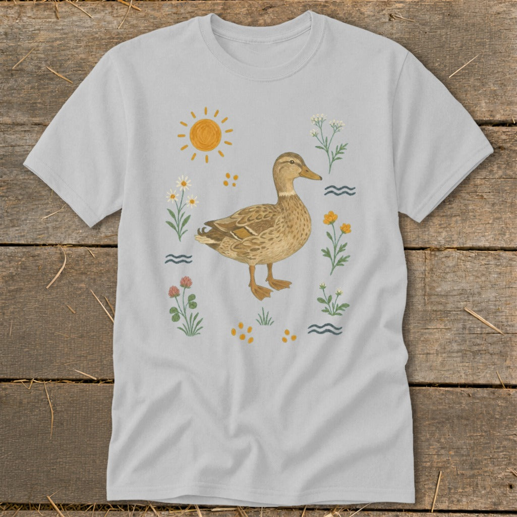 T-shirt featuring a watercolor illustration of a mallard duck surrounded by flowers and a sun.