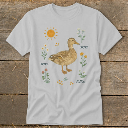 T-shirt featuring a watercolor illustration of a mallard duck surrounded by flowers and a sun.