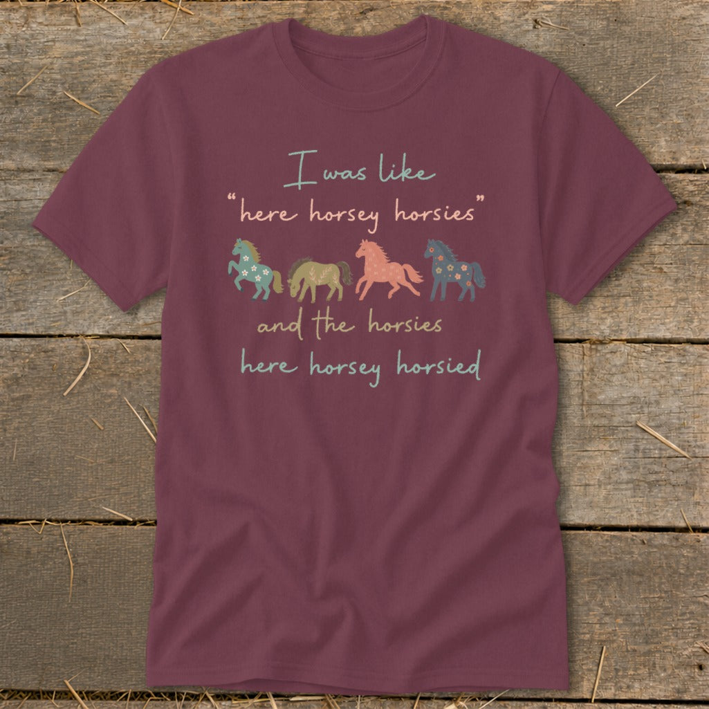 Maroon t-shirt with cartoon horses and text "I was like 'here horsey horsies' and the horsies here horsey horsied".
