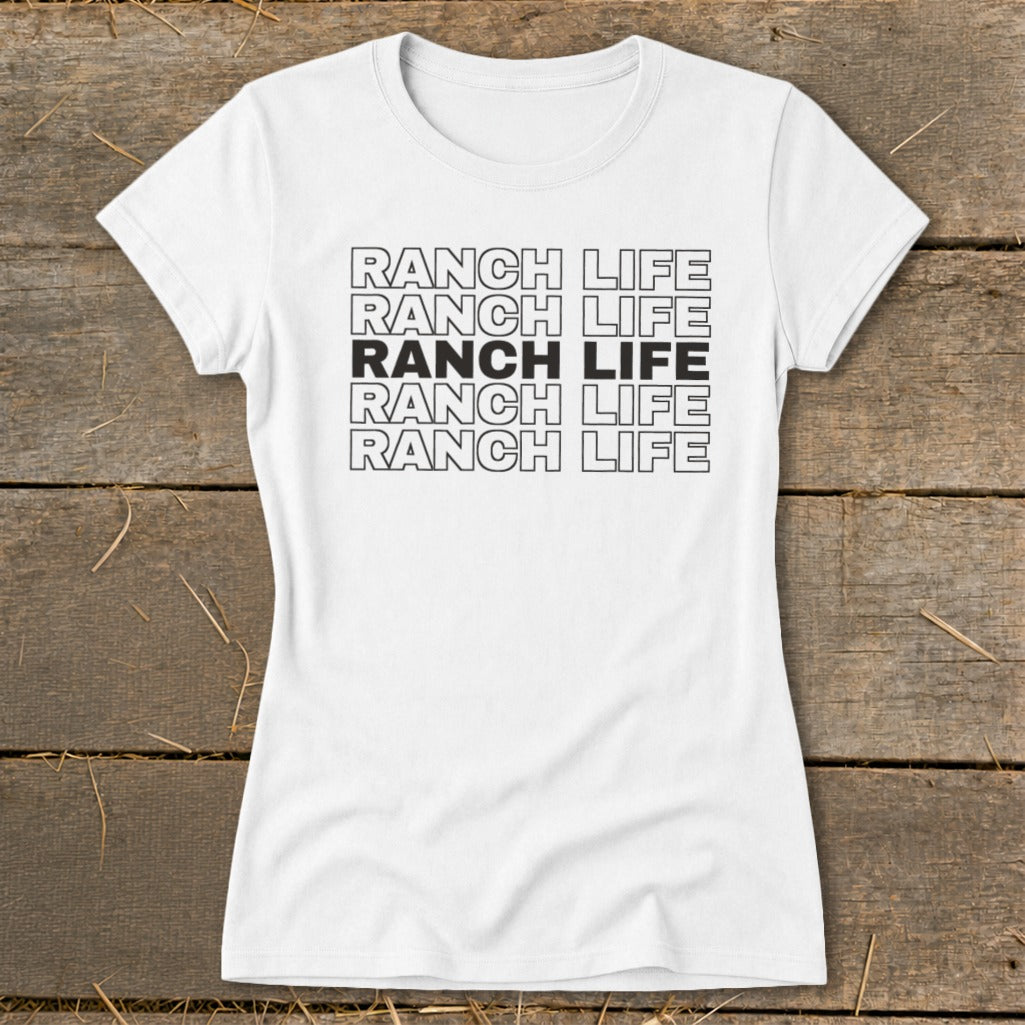 A white short-sleeved t-shirt with five stacked rows of the text RANCH LIFE, with the middle row solid black.