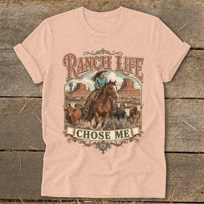 Ranch Life chose me graphic on a pink t-shirt with cowboy, horse, longhorns, and desert landscape.