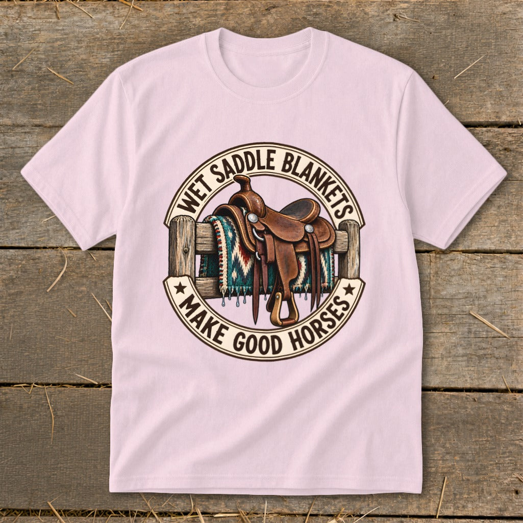 Saddle on fence with blanket and text "Wet Saddle Blankets Make Good Horses".