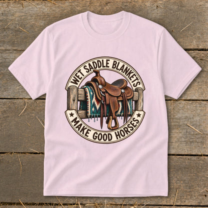 Saddle on fence with blanket and text "Wet Saddle Blankets Make Good Horses".