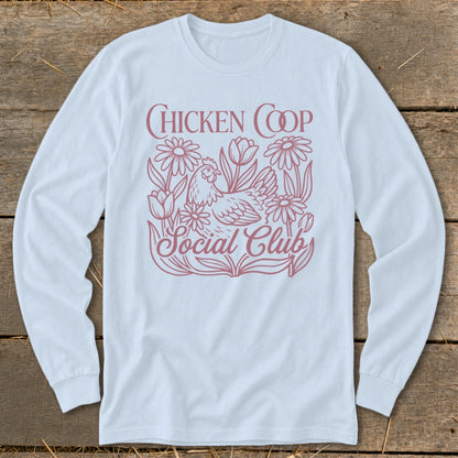 White long-sleeve shirt with "Chicken Coop Social Club" text and chicken and floral design.