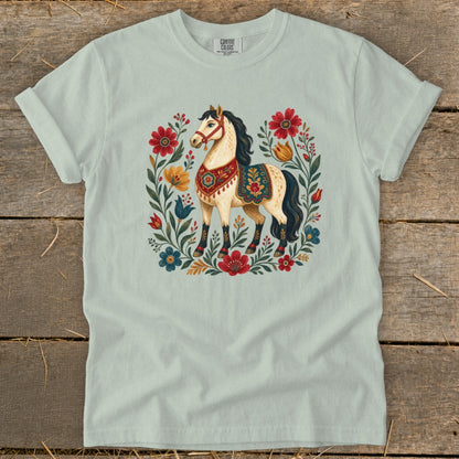 Light blue t-shirt featuring a cream horse surrounded by colorful floral motifs.
