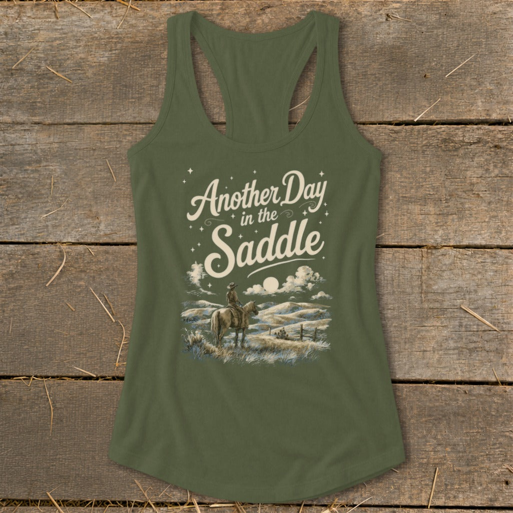 Olive green tank top with "Another Day in the Saddle" text and cowboy on horseback.