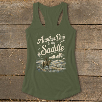 Olive green tank top with "Another Day in the Saddle" text and cowboy on horseback.