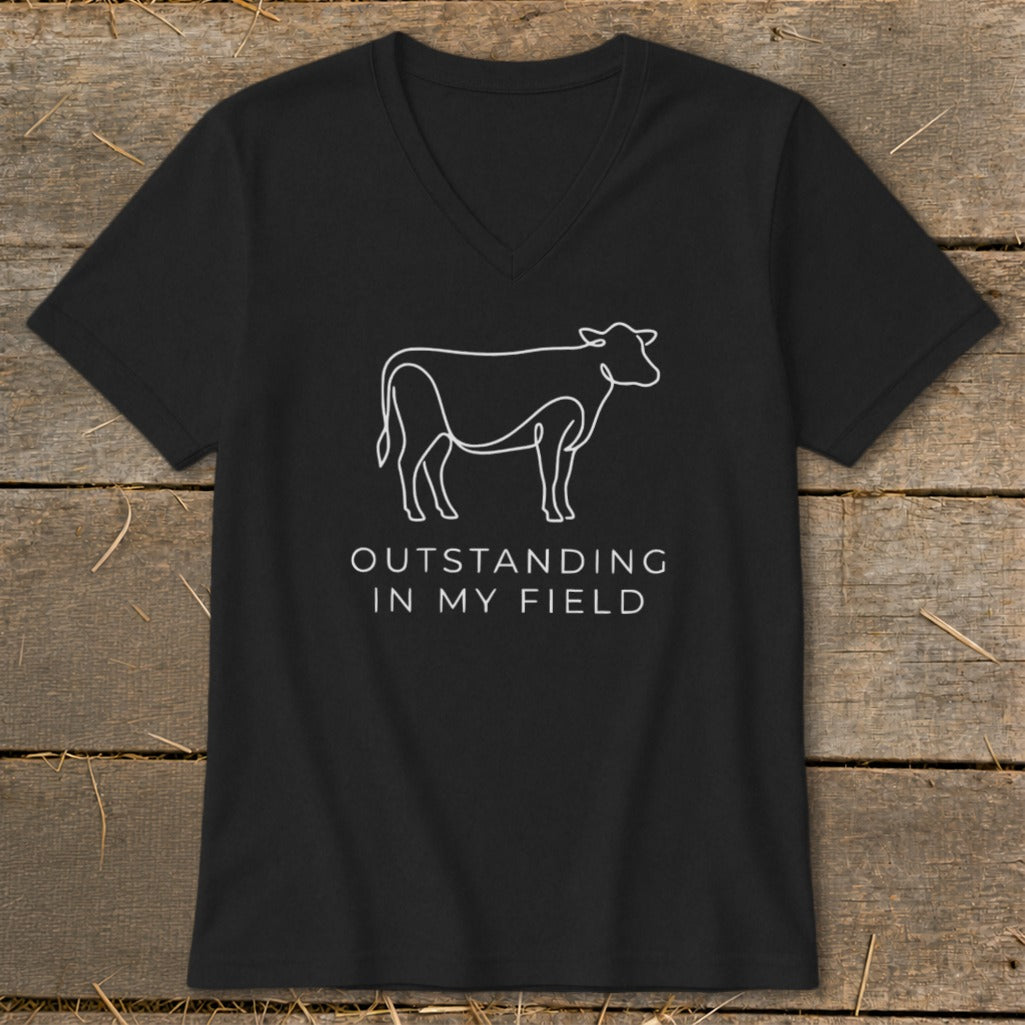 Black t-shirt with white line drawing of a cow and text "OUTSTANDING IN MY FIELD".