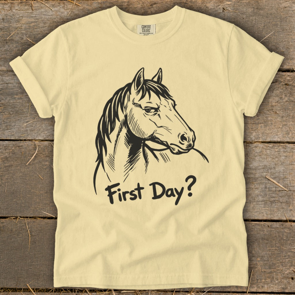 Light yellow t-shirt with black horse head graphic and "First Day?" text.