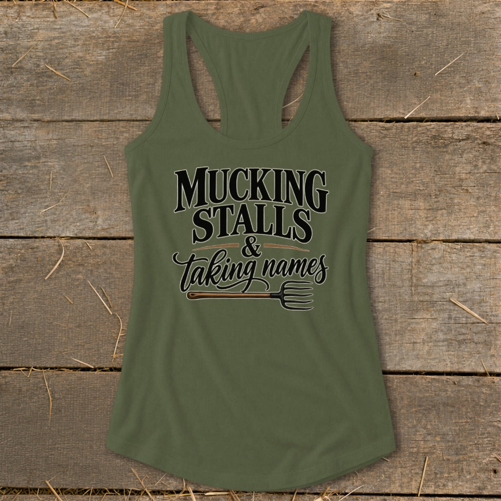 Green tank top with "MUCKING STALLS & Taking names" and a pitchfork graphic.
